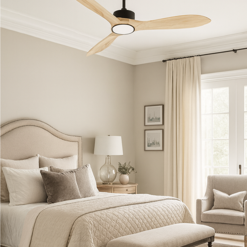 Neatly decorated bedroom with a ceiling fan, bed, lamp, and armchair.